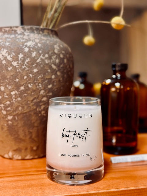 Vigueur Fragrances But, First soy candle with coffee, caramel, and cream notes in a clear glass jar