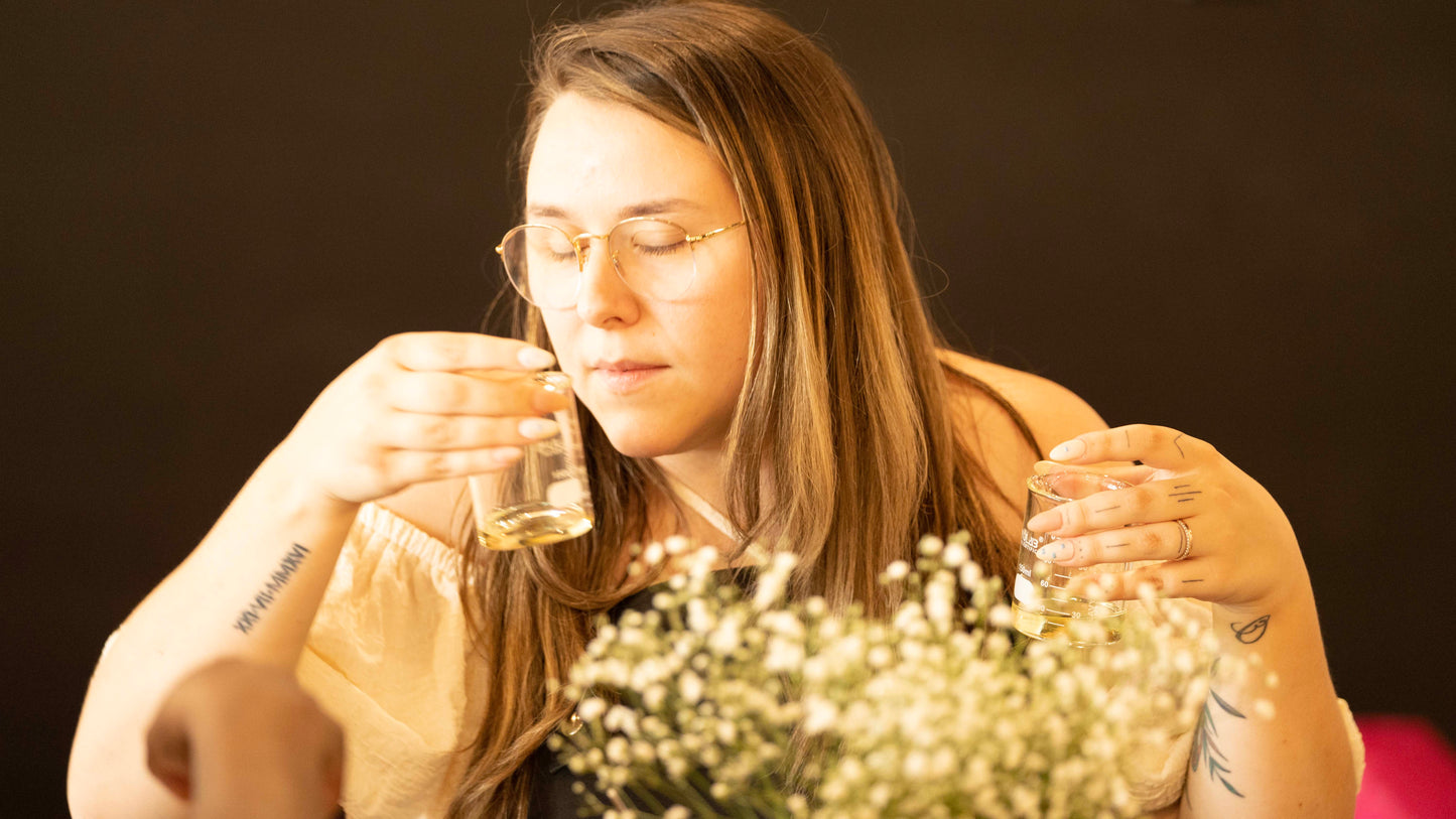 Woman smelling fragrance blends at candle workshop