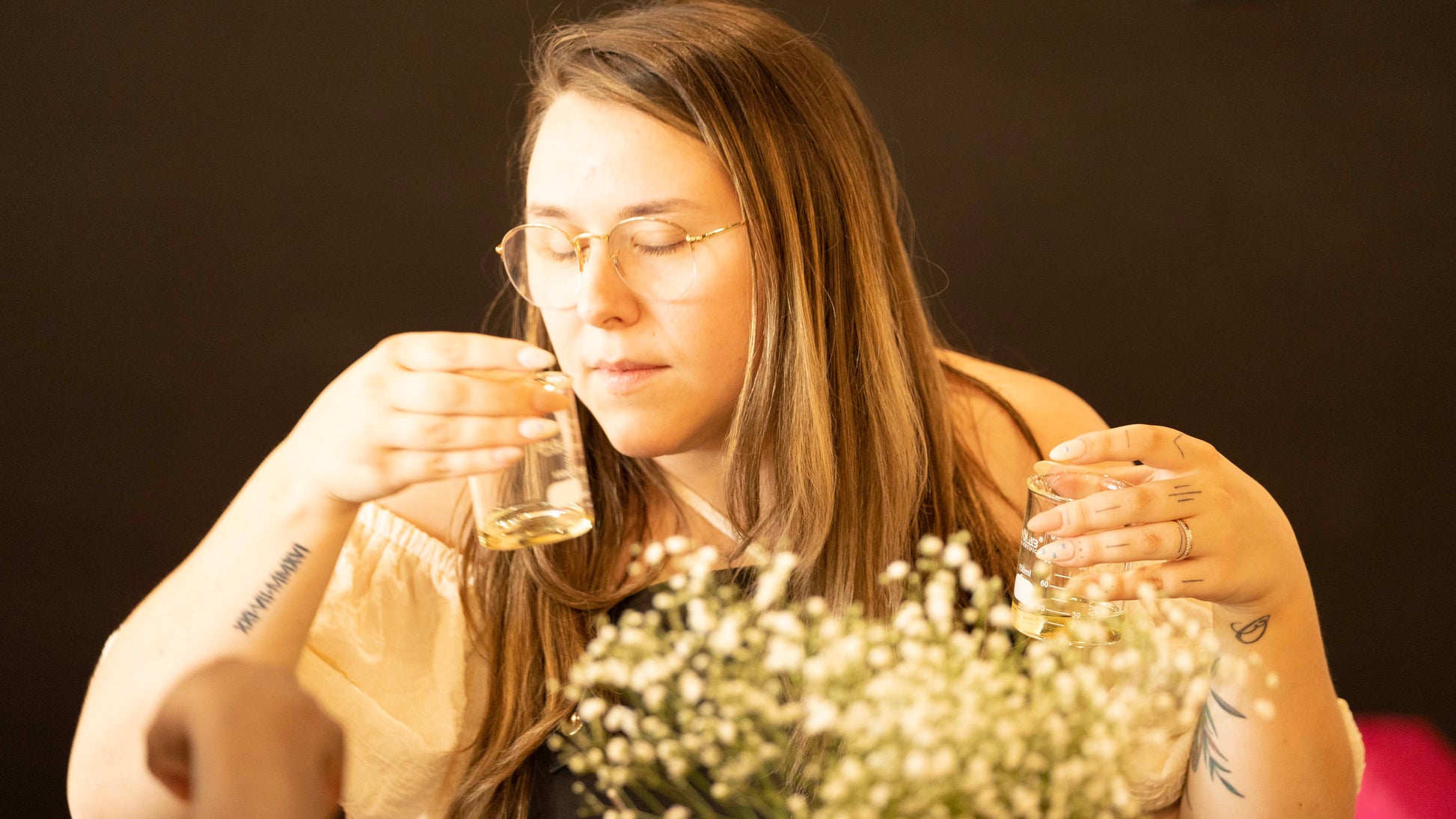 Woman smelling fragrance blends at candle workshop