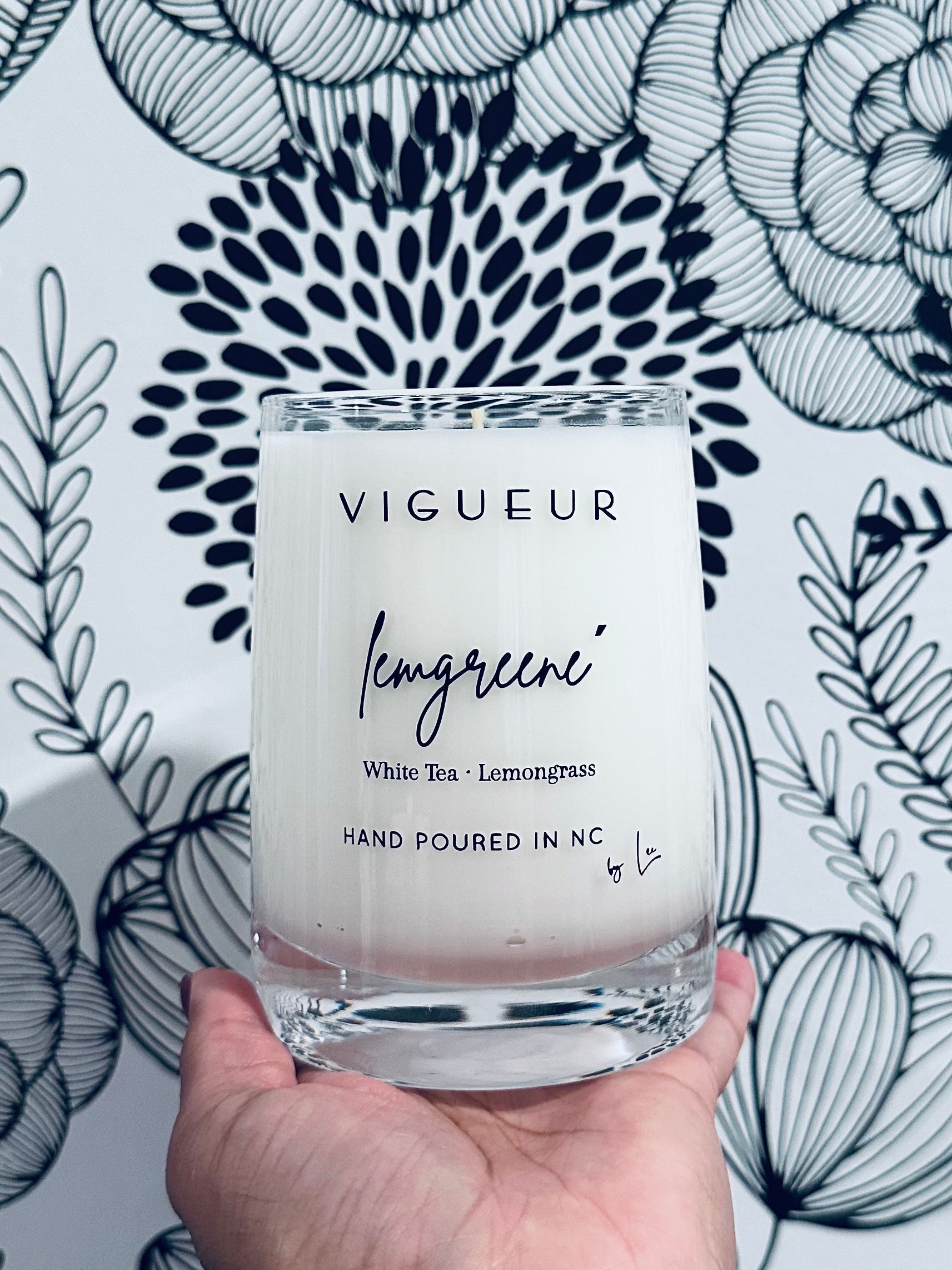 Vigueur Fragrances L E M G R E E N É soy candle with lemongrass, white tea, and citrus notes in a clear glass jar