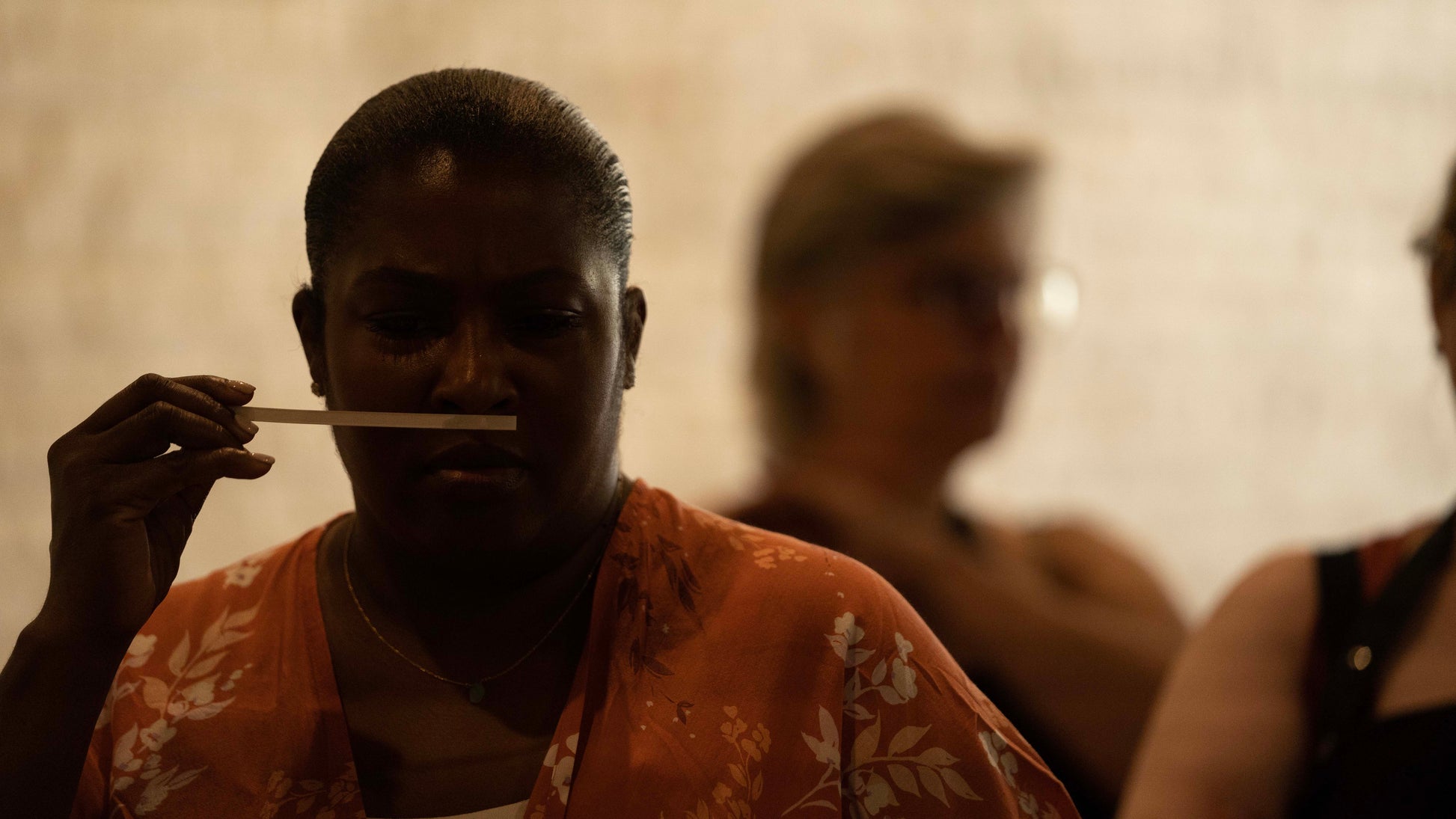 Woman Testing and Smelling fragrance and essential oils at candle workshop